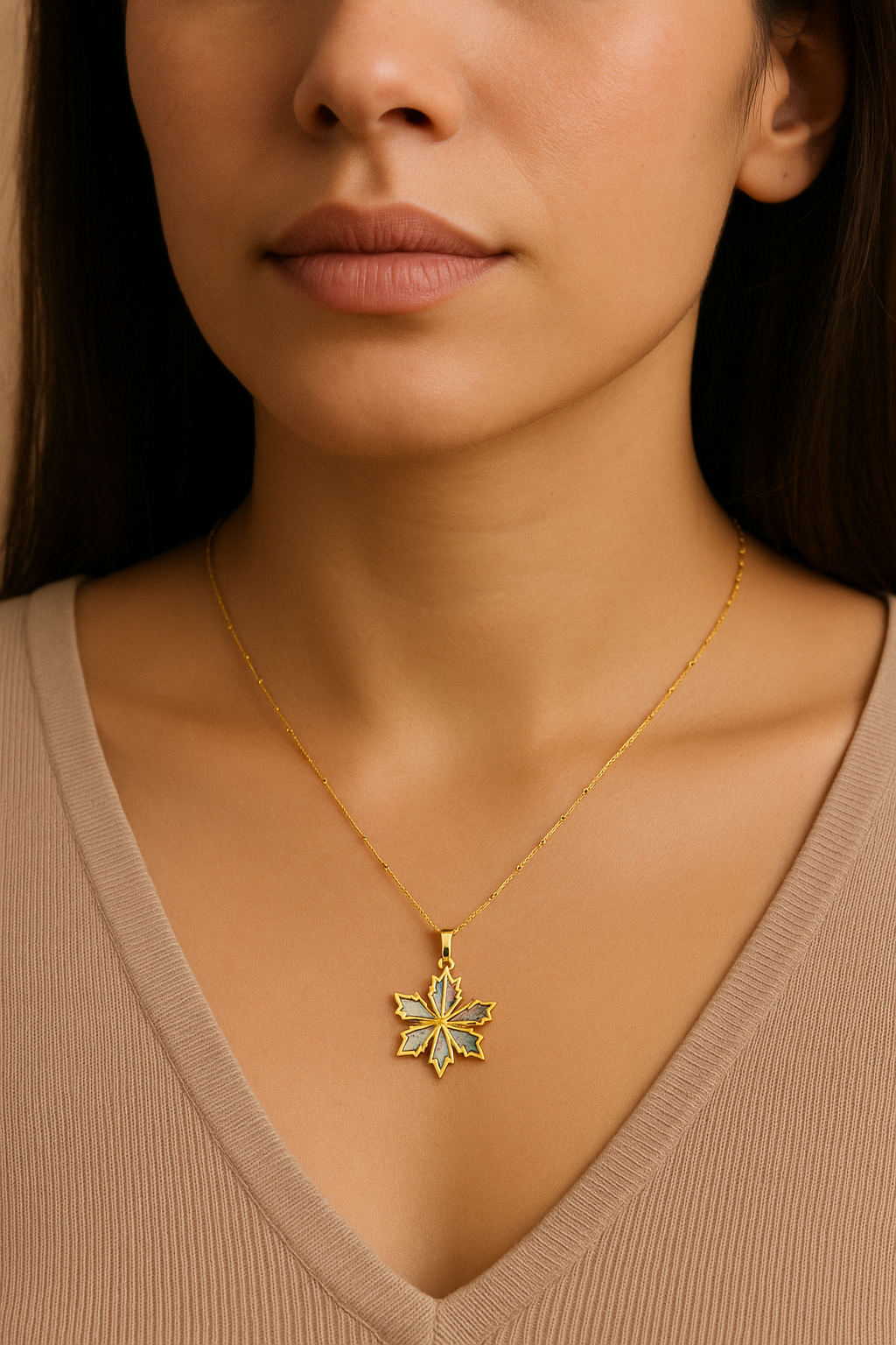 Close-up of a woman wearing a gold necklace with a star-shaped pendant.