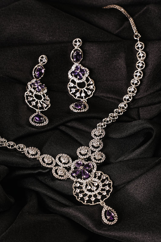Silver necklace with purple gemstones on a black fabric background